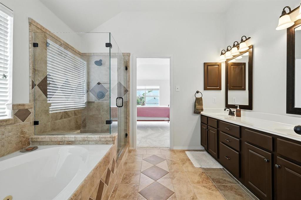 5713 Green Hollow Lane The Colony, TX 75056 - Photo 21 of 29 a spacious bathroom with a tub sink and mirror