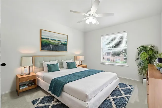 a bedroom with a bed a couch and a window