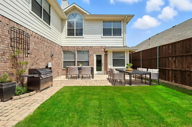 a chair and table in front of a house