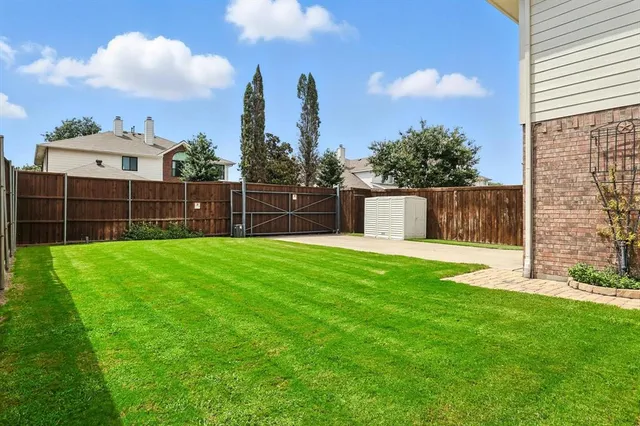 a view of a backyard with a garden and entertaining space