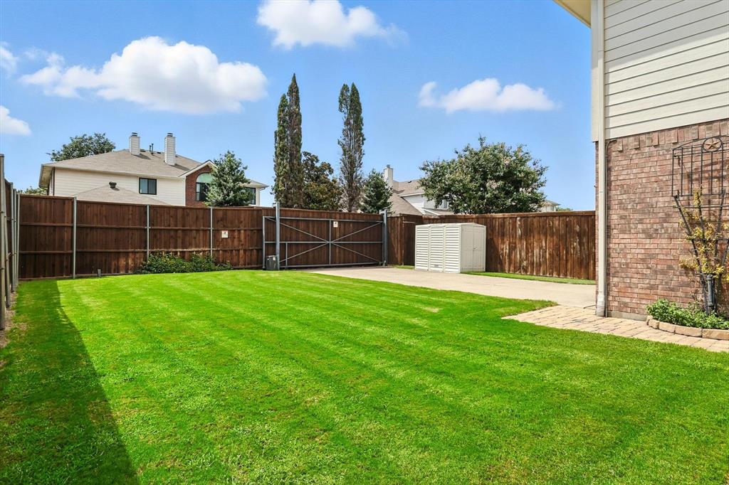 5713 Green Hollow Lane The Colony, TX 75056 - Photo 29 of 29 a view of a backyard with a garden and entertaining space