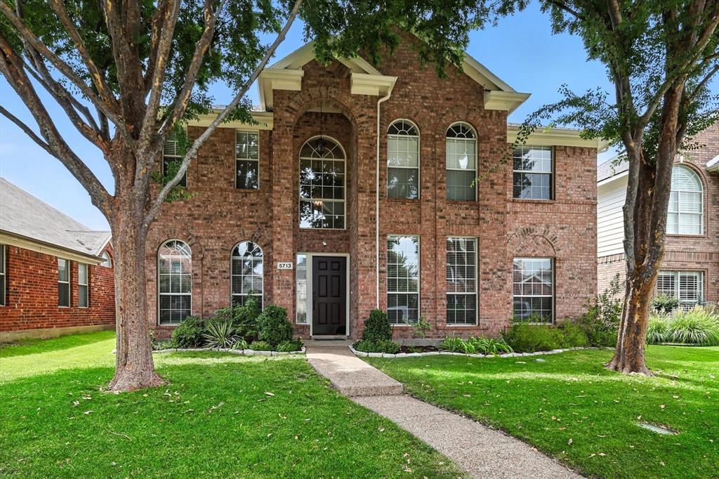 5713 Green Hollow Lane The Colony, TX 75056 - Photo 3 of 29 a front view of a house with garden