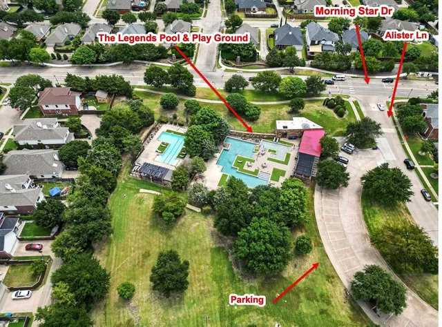 an aerial view of residential houses with outdoor space and street view