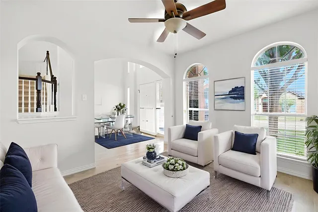 a living room with furniture and wooden floor