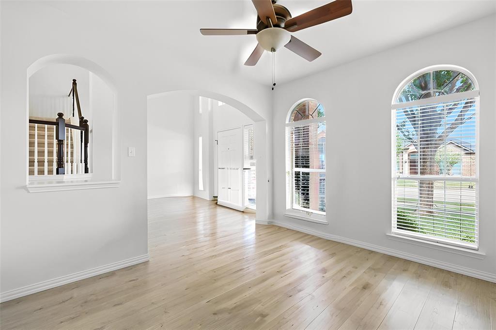5713 Green Hollow Lane The Colony, TX 75056 - Photo 9 of 29 a view of a room with wooden floor chandelier and a window