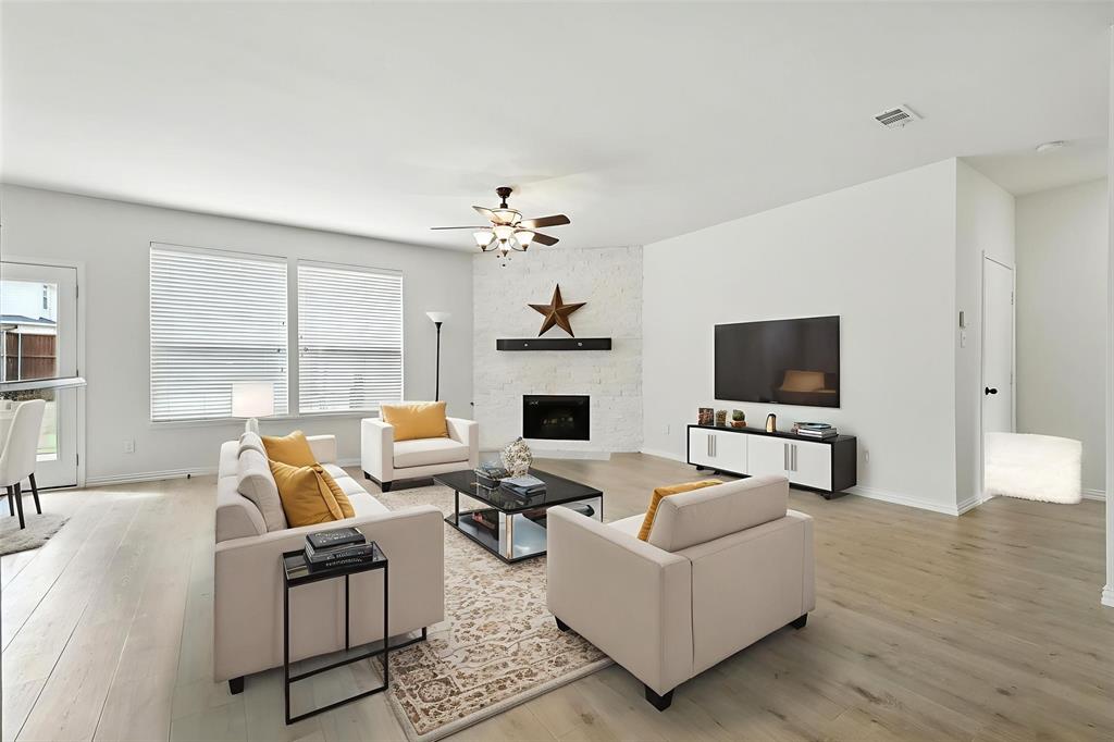 5713 Green Hollow Lane The Colony, TX 75056 - Photo 10 of 29 a living room with fireplace furniture and a flat screen tv