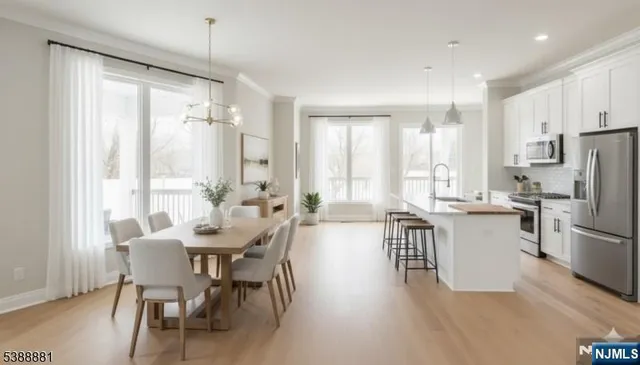 a view of a dining room with furniture large windows and wooden floor