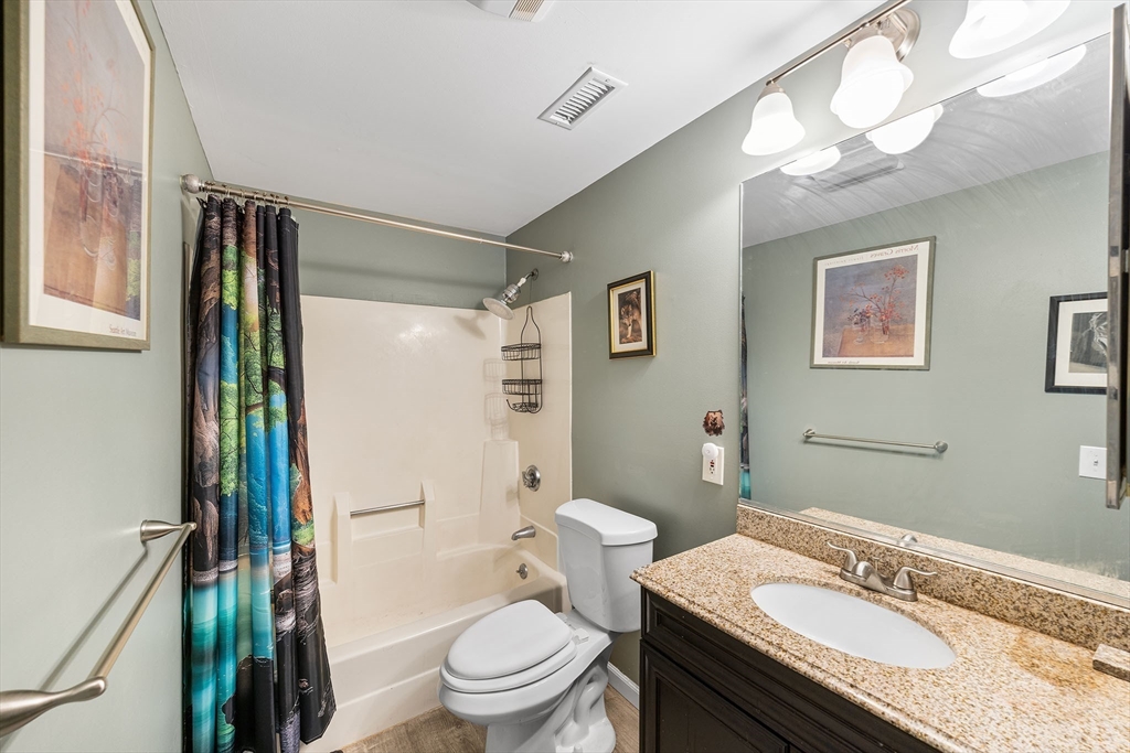 315 Rantoul Street, Unit 402 Beverly, MA 01915 - Photo 14 of 27 a bathroom with a granite countertop sink toilet and shower