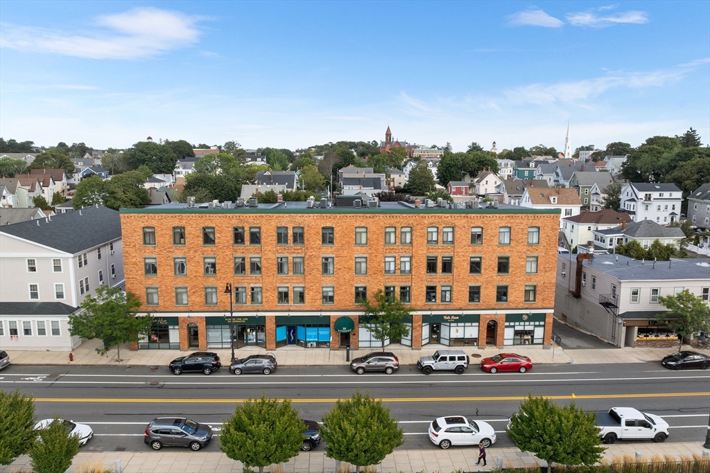315 Rantoul Street, Unit 402 Beverly, MA 01915 - Photo 21 of 27 a large building with a street sign