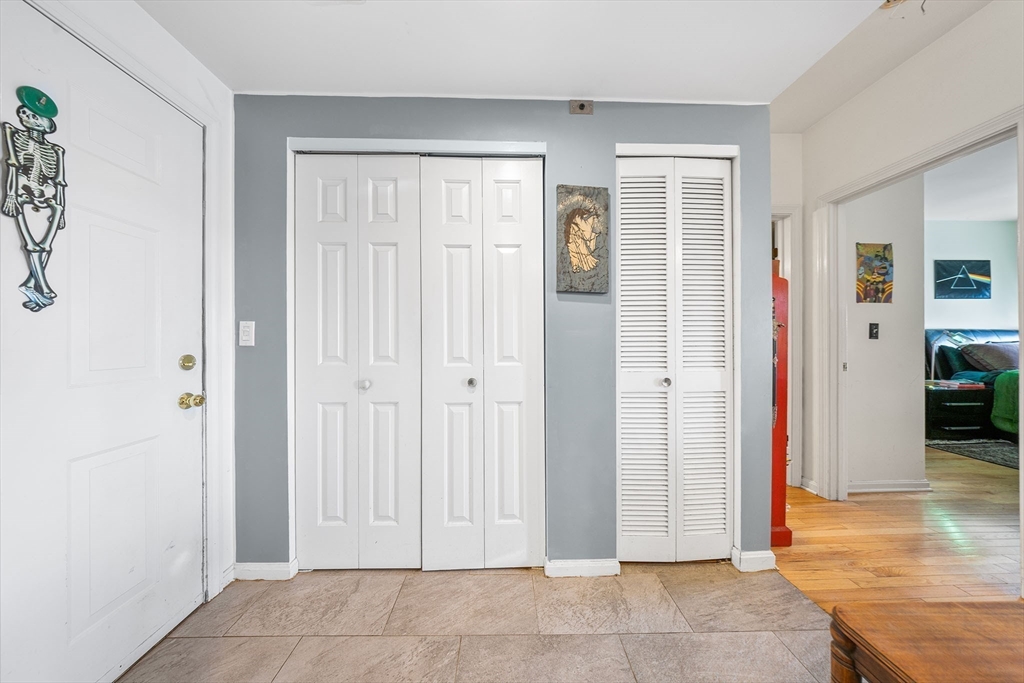 315 Rantoul Street, Unit 402 Beverly, MA 01915 - Photo 4 of 27 a view of a livingroom with wooden floor and a cabinet door