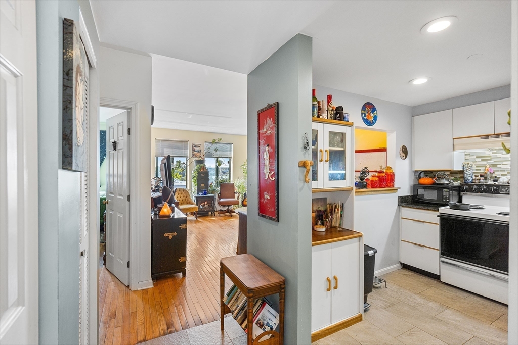 315 Rantoul Street, Unit 402 Beverly, MA 01915 - Photo 5 of 27 a kitchen with stainless steel appliances granite countertop a refrigerator and a stove