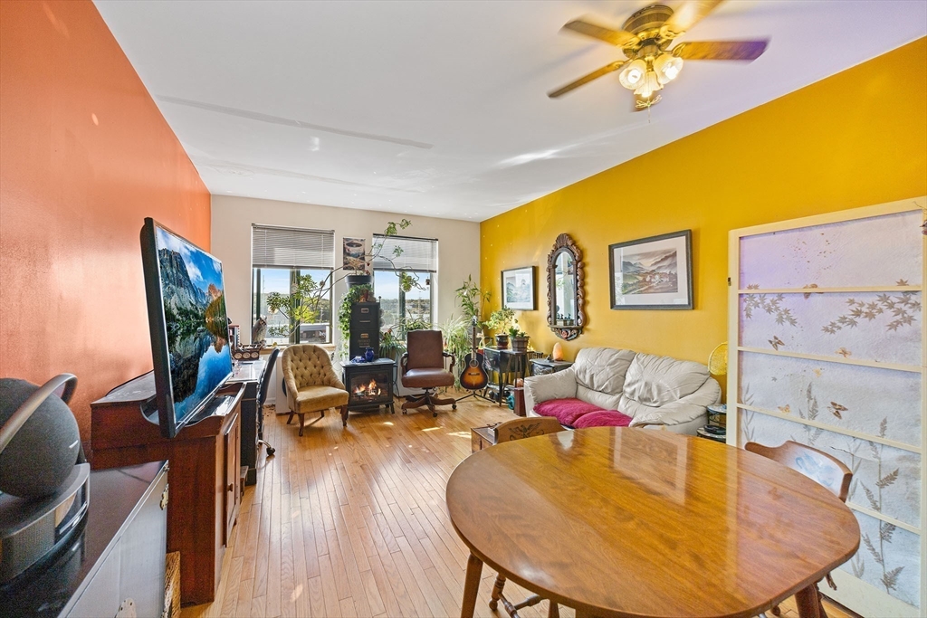 315 Rantoul Street, Unit 402 Beverly, MA 01915 - Photo 8 of 27 a living room with furniture and wooden floor
