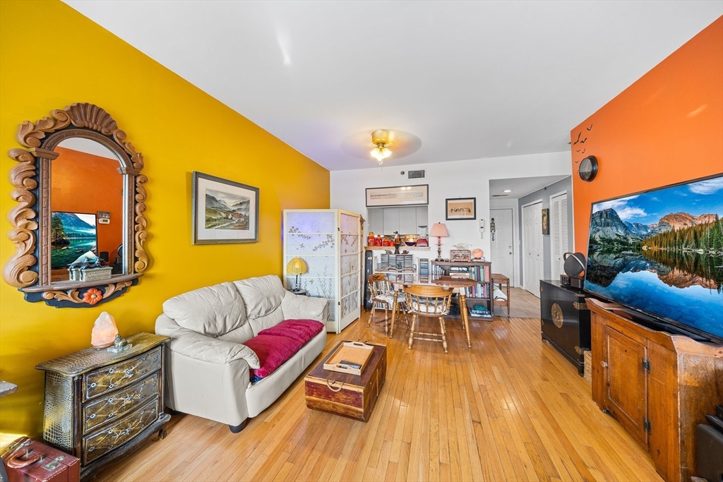 315 Rantoul Street, Unit 402 Beverly, MA 01915 - Photo 9 of 27 a living room with furniture and wooden floor