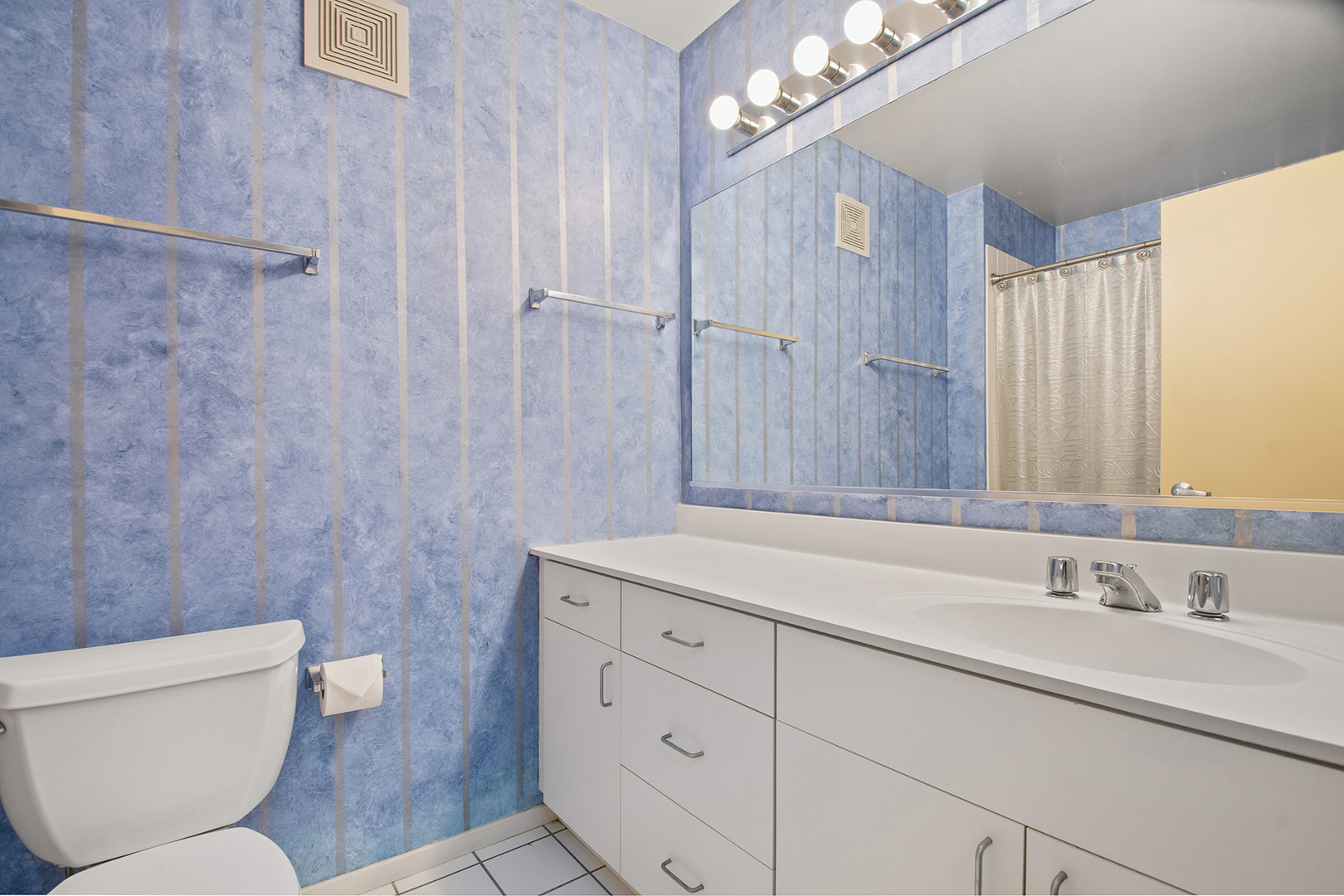 507 Kelburn Road Deerfield, IL 60015 - Photo 17 of 26 a bathroom with a sink a toilet a mirror a vanity and shower