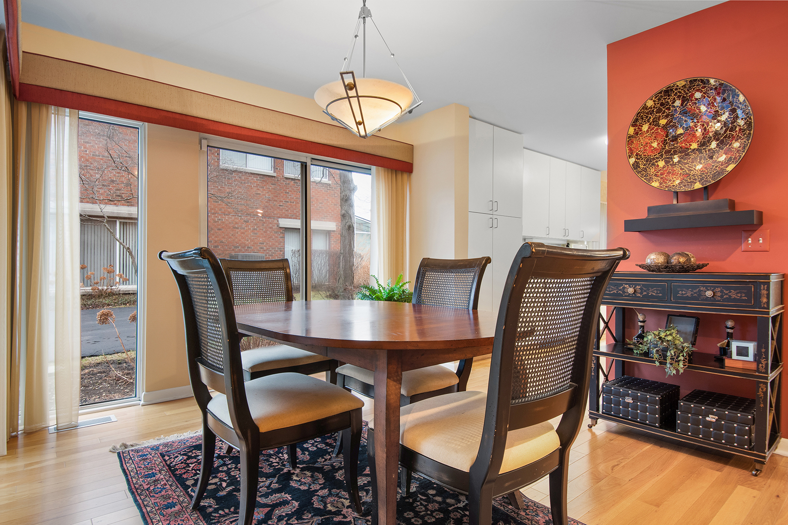 507 Kelburn Road Deerfield, IL 60015 - Photo 3 of 26 a dining room with furniture a rug a potted plant and a chandelier