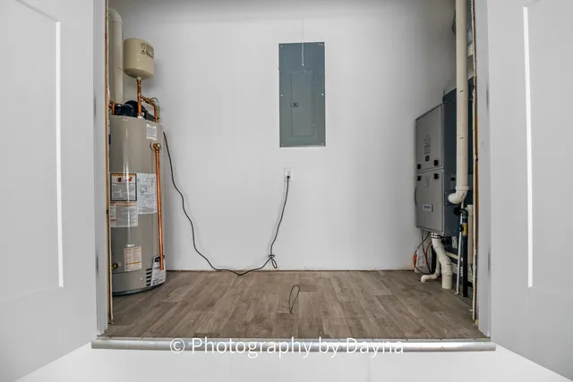 a view of a room with wooden floor and a hallway