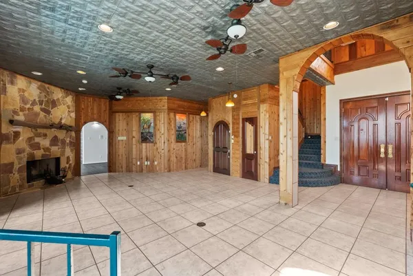 a large room with kitchen island granite countertop a large counter top space and stainless steel appliances