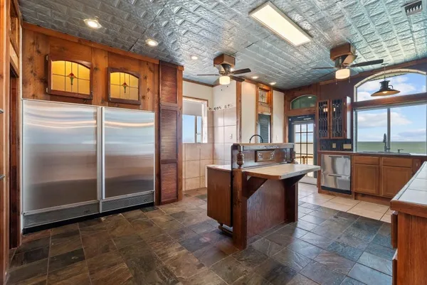 a kitchen with stainless steel appliances granite countertop a refrigerator a oven and a sink