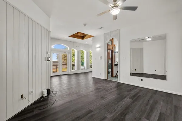 a view of living room with furniture and large windows