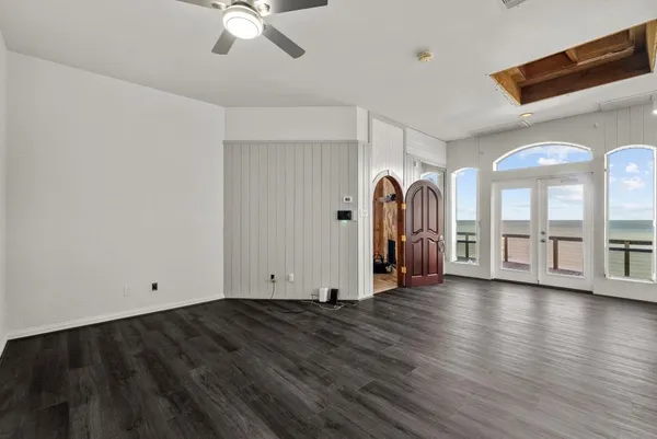 a view of a kitchen with stainless steel appliances granite countertop a stove and a window
