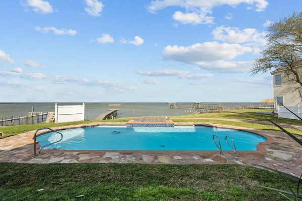 a view of a swimming pool with an outdoor seating and yard