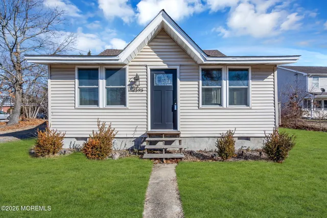a front view of house with yard and green space
