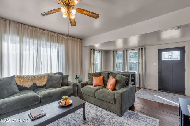a view of a dining room with furniture and wooden floor