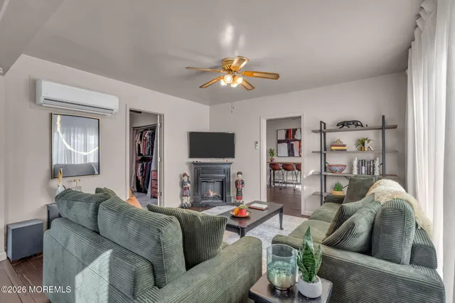 a living room with fireplace furniture and a flat screen tv