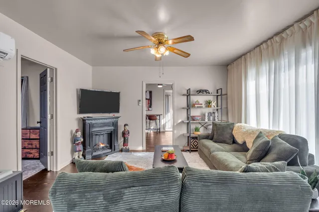 a living room with furniture a flat screen tv and a fireplace