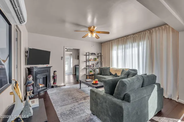 a living room with furniture a fireplace and a chandelier