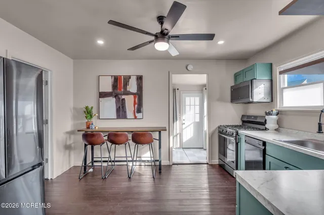 a kitchen with cabinets counter and stainless steel appliances