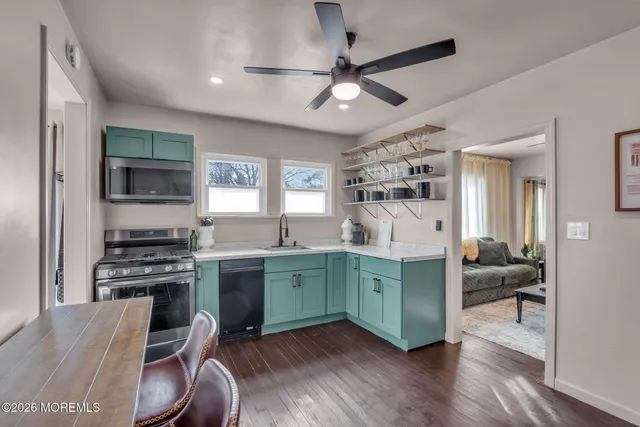 a kitchen with stainless steel appliances granite countertop a refrigerator a stove and a sink