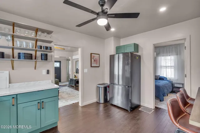 a view of a kitchen with furniture and a refrigerator