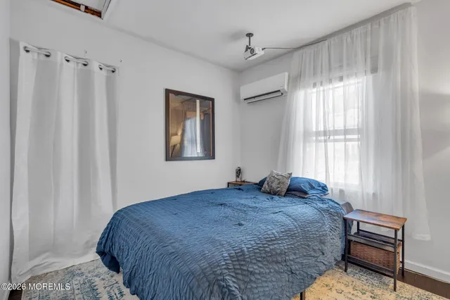 a bathroom with a sink toilet a mirror and shower