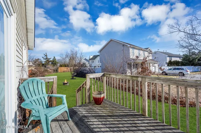 a view of a backyard with table and chairs under an umbrella