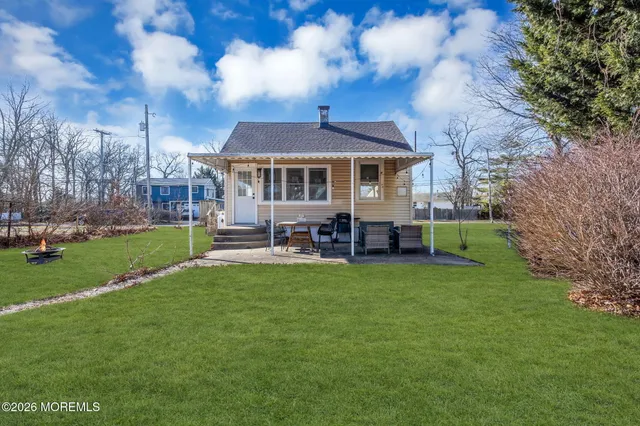 a view of a house with a backyard and porch