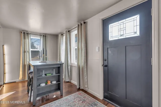a view of a hallway with furniture and window