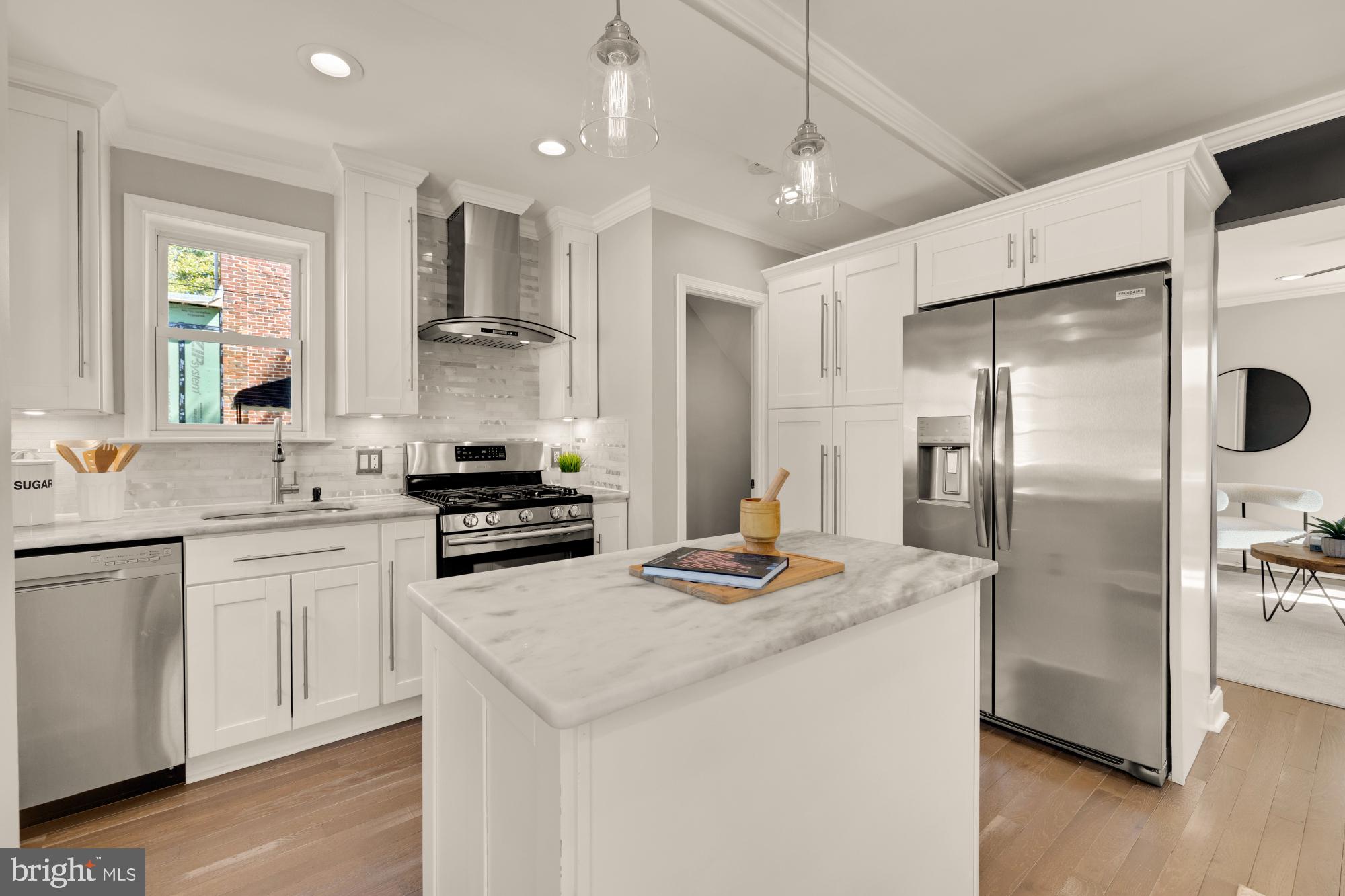 2414 Perry Street Northeast Washington, DC 20018 - Photo 15 of 49 a kitchen with stainless steel appliances granite countertop a sink a stove a refrigerator and island