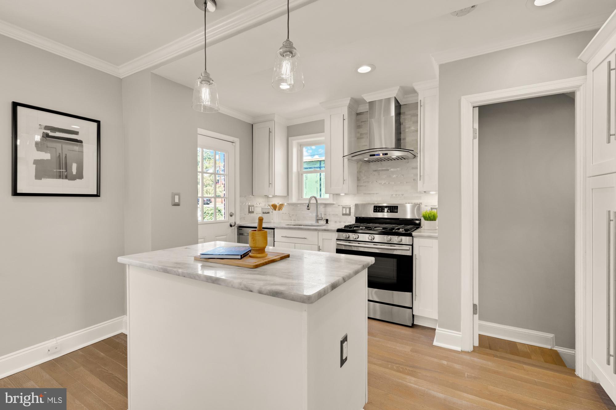 2414 Perry Street Northeast Washington, DC 20018 - Photo 16 of 49 a kitchen with a stove a sink and a refrigerator