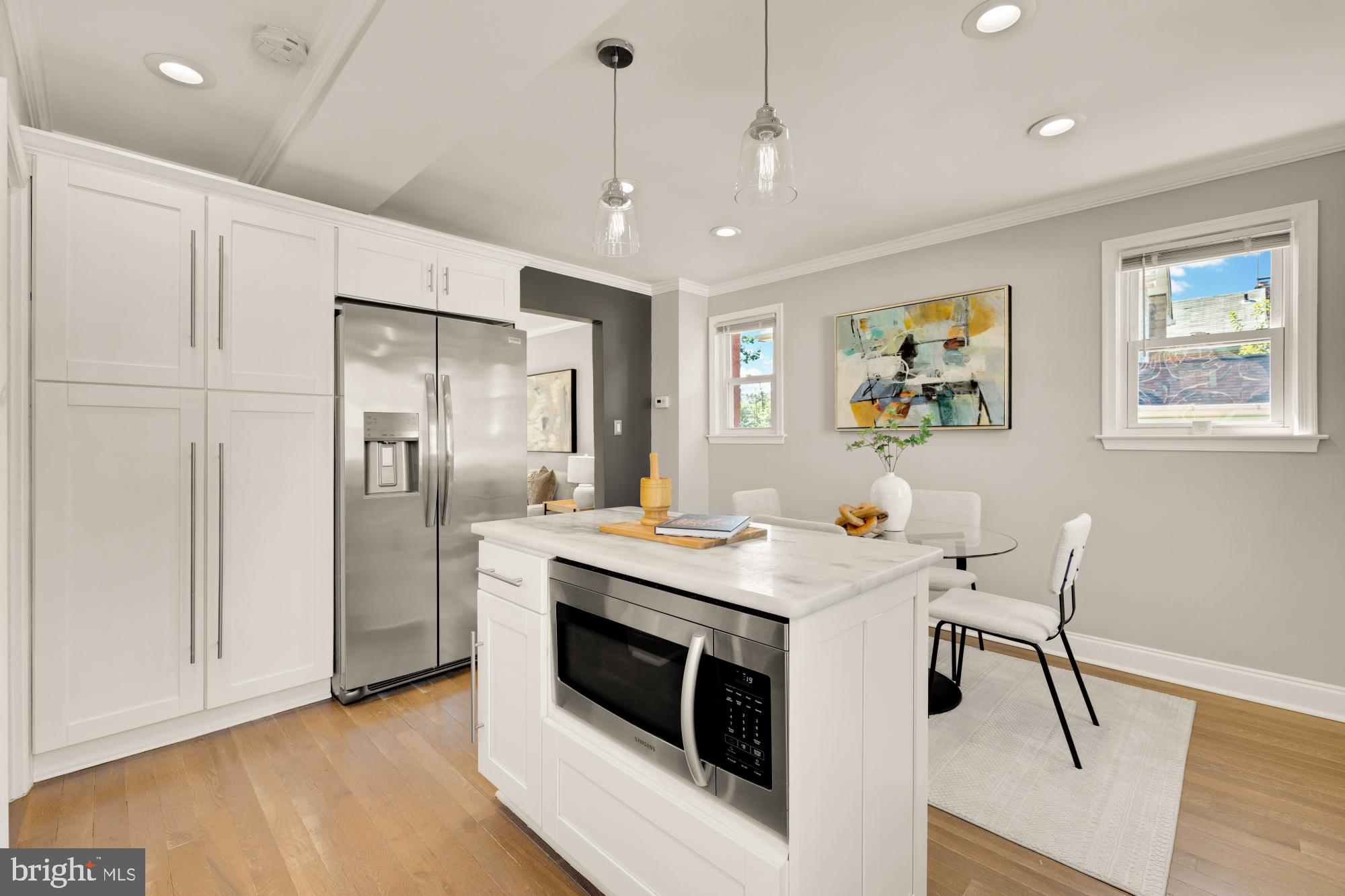 2414 Perry Street Northeast Washington, DC 20018 - Photo 20 of 49 a open kitchen with stainless steel appliances granite countertop a stove a refrigerator a oven a sink a dining table and chairs with wooden floor