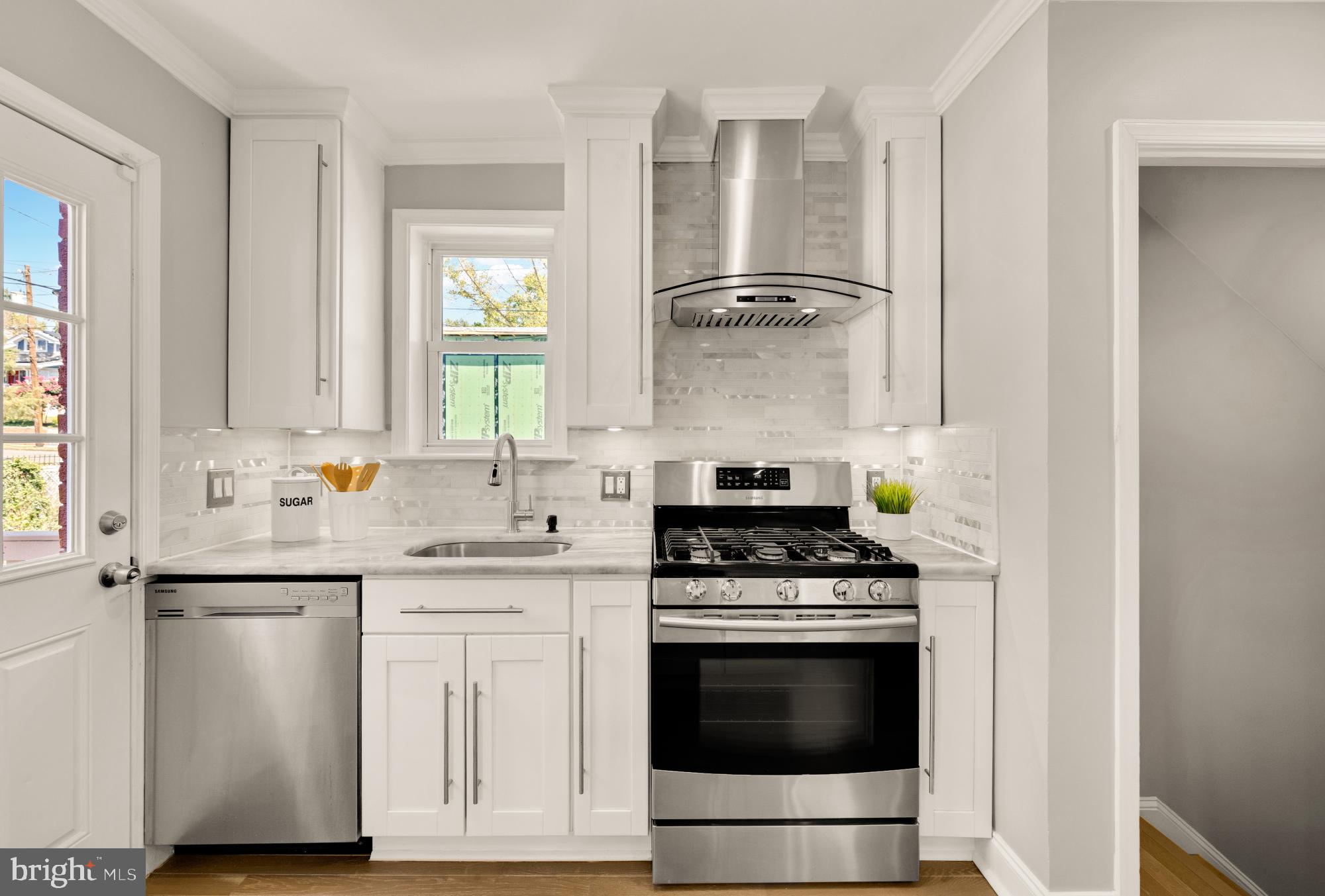 2414 Perry Street Northeast Washington, DC 20018 - Photo 21 of 49 a kitchen with white cabinets and appliances