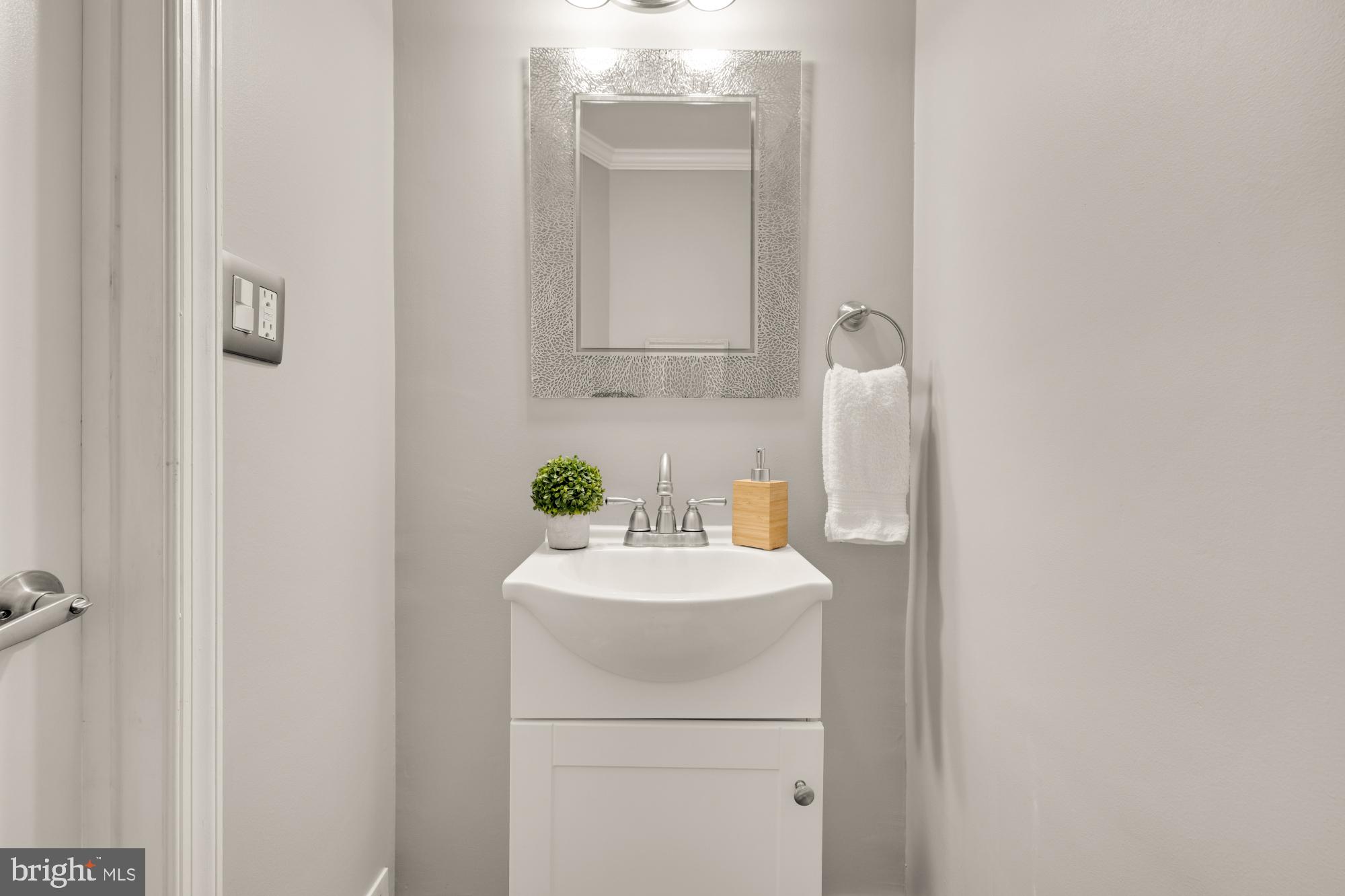 2414 Perry Street Northeast Washington, DC 20018 - Photo 22 of 49 a bathroom with a sink and a mirror