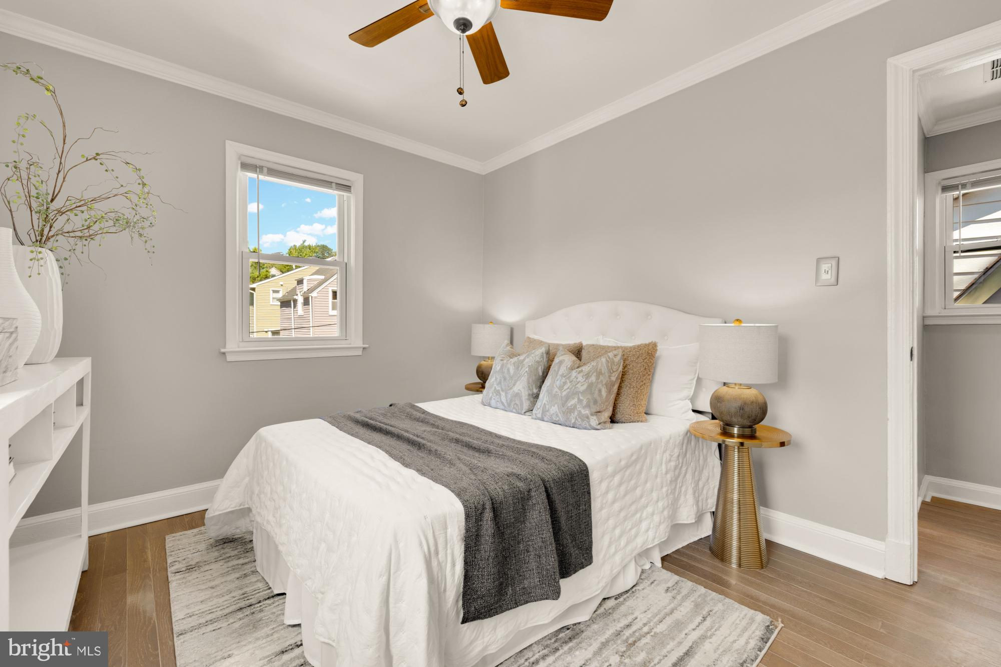 2414 Perry Street Northeast Washington, DC 20018 - Photo 26 of 49 a bedroom with a bed and a chandelier