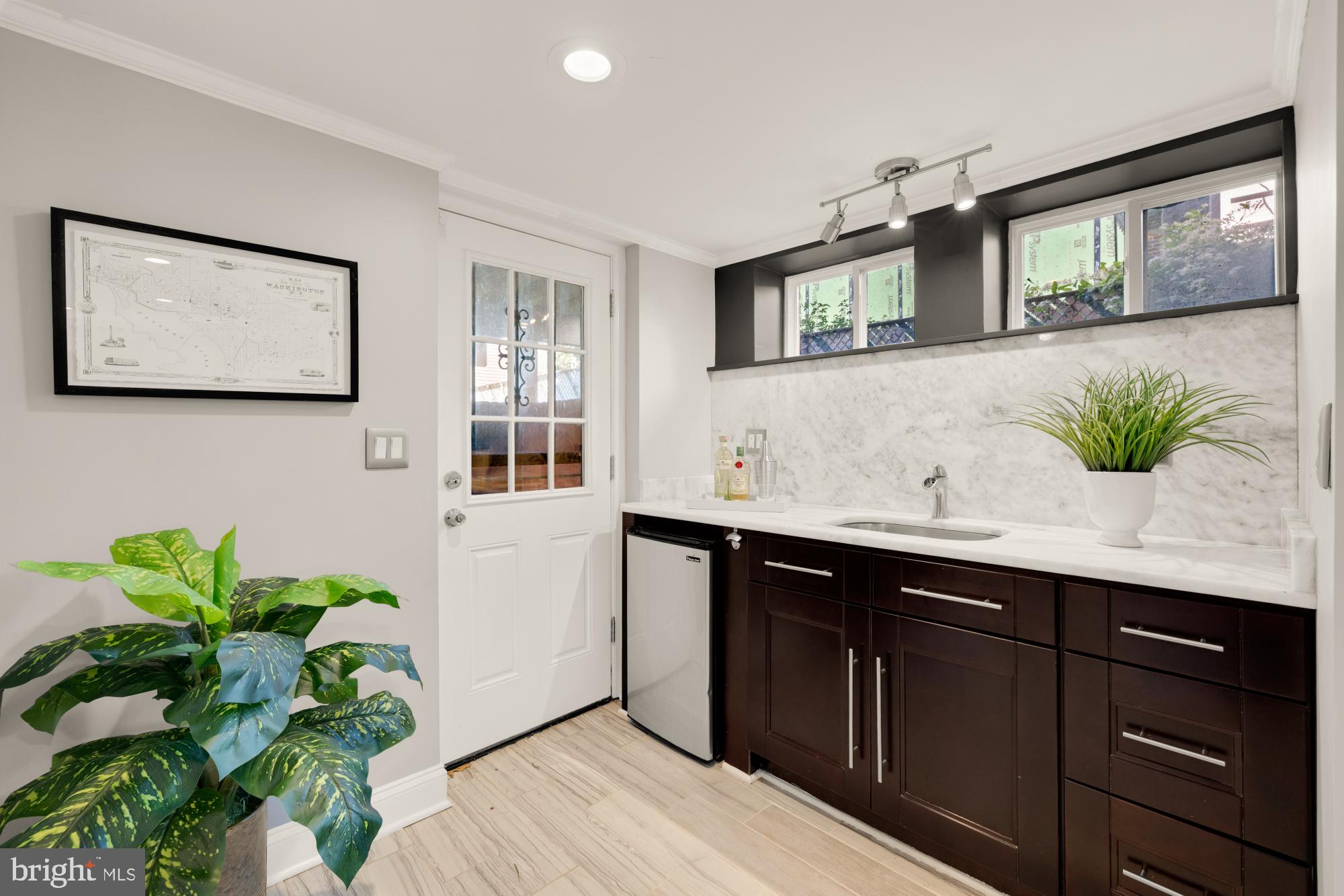 2414 Perry Street Northeast Washington, DC 20018 - Photo 40 of 49 a bathroom with a sink a mirror and a potted plant