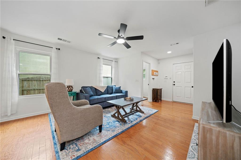 151 Nacoochee Way Canton, GA 30114 - Photo 12 of 36 a living room with furniture and a flat screen tv