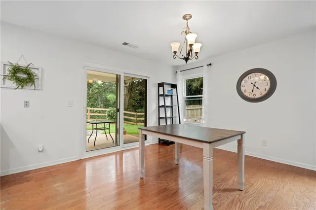 a view of a room with furniture large window and wooden floor