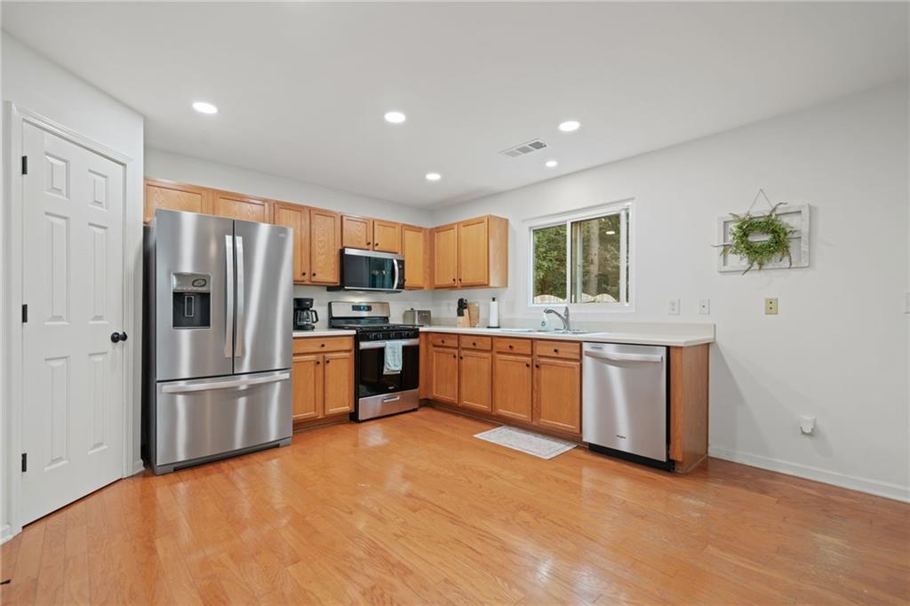 151 Nacoochee Way Canton, GA 30114 - Photo 17 of 36 a kitchen with granite countertop a refrigerator stove top oven and sink