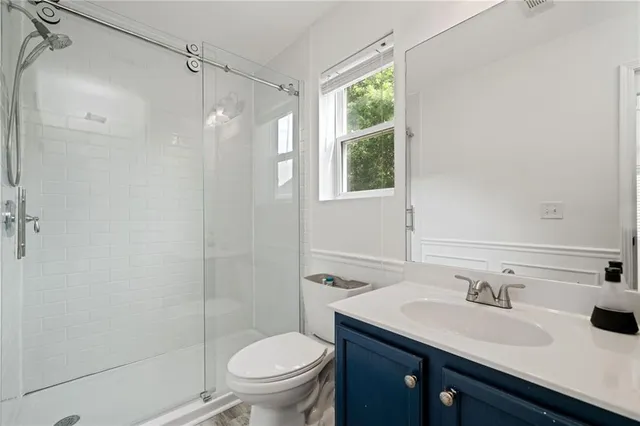a bathroom with a sink toilet and shower