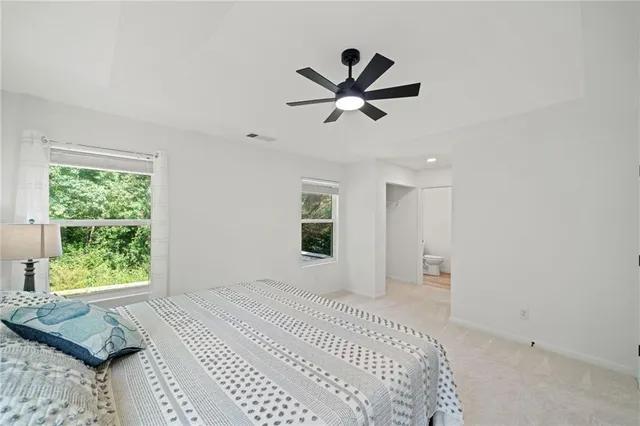 a view of a bedroom with a bed and a window