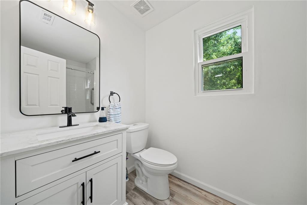 151 Nacoochee Way Canton, GA 30114 - Photo 30 of 36 a bathroom with a toilet a sink a vanity and mirror